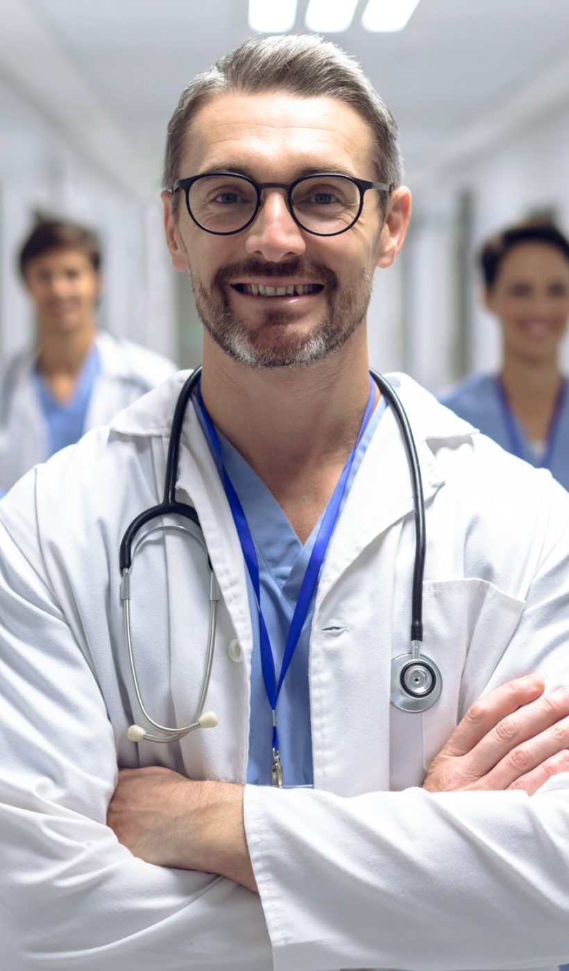 diverse-medical-team-of-doctors-looking-at-camera-while-holding-clipboard-and-medical-files.jpg